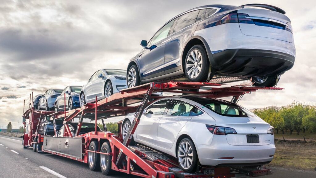Dealership vehicle transport with an auto carrier ready for dealer pickup