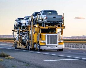 Dealer car shipping truck transporting vehicles from Alabama to Minnesota on an interstate route