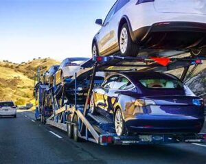Dealer car shipping truck transporting vehicles from Alabama to Minnesota on an interstate route