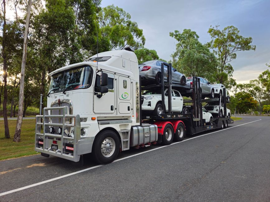Car being loaded onto an auto transport truck showcasing benefits